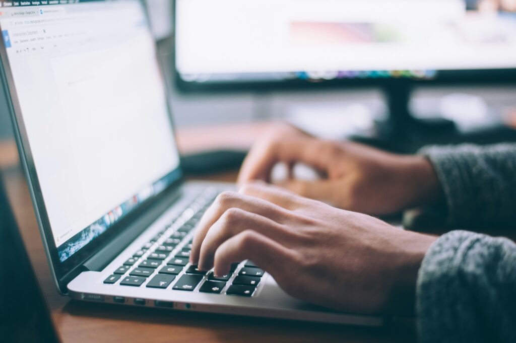 Close up of student typing on laptop