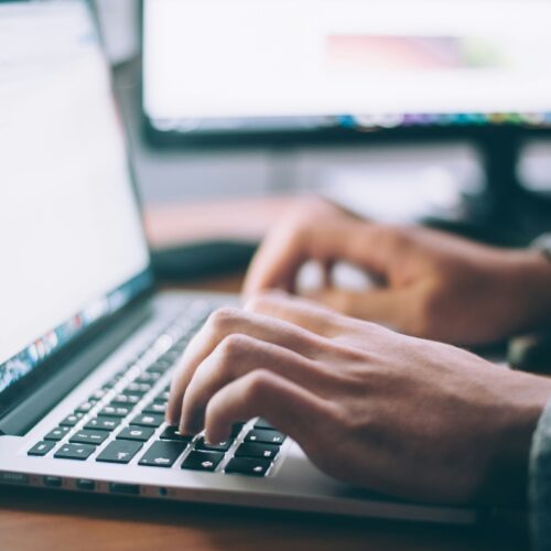 Close up of student typing on laptop