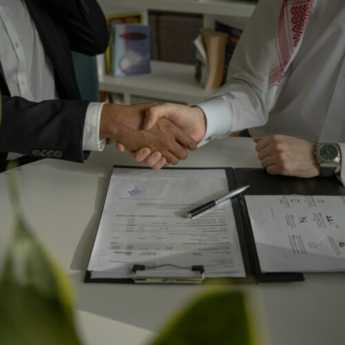 Cosigner and student signing contract/reviewing documents
